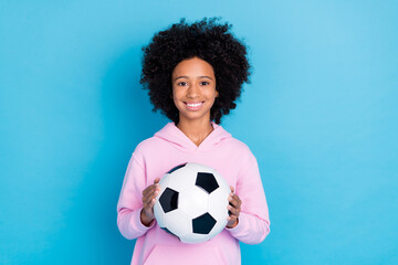 Photo of young pretty girl hold soccer ball player exercise sporty isolated over blue color background