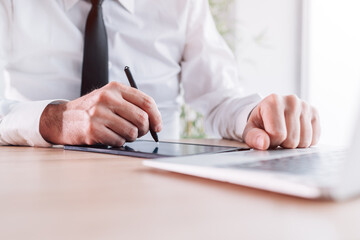 Businessman signing contract agreement with stylus pen and e-sign pad in office