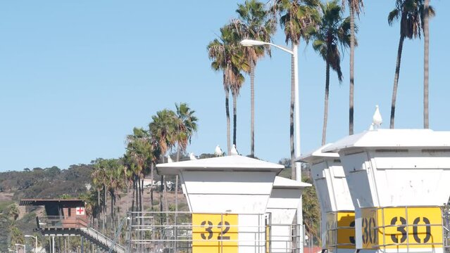 Lifeguard stand or life guard tower hut, surfing safety on California beach, USA. Summer pacific ocean aesthetic. Rescue station, coast lifesavers wachtower or house, palm trees in La Jolla, San Diego