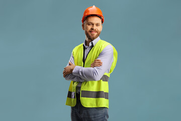 Young male site engineer with a safety vest and hardhat