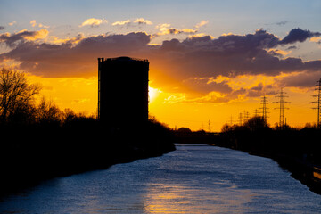 Inland ship canal “Rhein-Herne-Kanal“ at sunset in Oberhausen Ruhr Basin Germany. Skyline with...