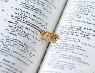 God is love, text quote written with golden letters on an open Christian Holy Bible Book. A...