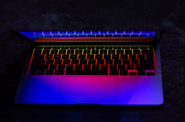 Laptop with backlit neon keyboard