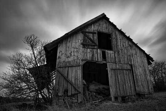 front view of an old spooky abandoned wooden barn