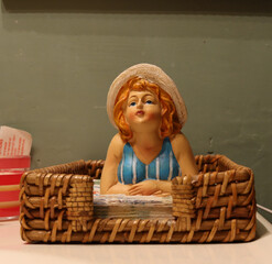 Napkin holder with a beautiful woman figurine