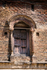 Fototapeta na wymiar 21 March 2022, Pandharpur, India, Old Vintage wooden door on retro wall, Pandharpur, India.