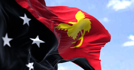 Detail of the national flag of Papua New Guinea waving in the wind on a clear day