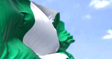 Detail of the national flag of Nigeria waving in the wind on a clear day