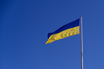 The national flag of Ukraine or Ukrainian flag flying proudly in the breeze.