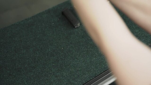 Woman hands grabs a gun, close-up