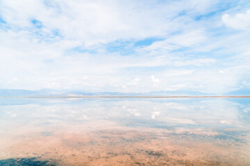 Reflections of the clouds in the clear water of the sea