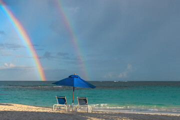 rainbow over the beach with umbrella