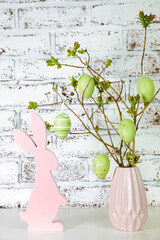 Decorative easter eggs on tree branches. branches decorated by easter eggs. Vase with tree branches on white background, colorful Easter eggs