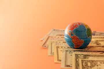 US banknotes and globe. Signs and symbols of global changes. The concept of currency in the world due to war and sanctions.