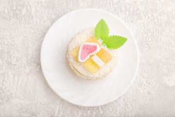 Decorated cake with milk and coconut cream on a gray concrete background. top view, close up.