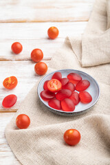 Jelly tomato candies on white wooden background. close up, side view.
