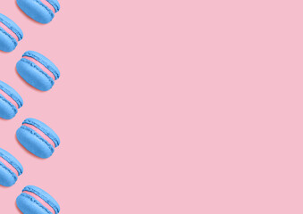 Macaroons. Template for posters and banners with copy space. Blue biscuits with berry filling on pink background. Minimal style