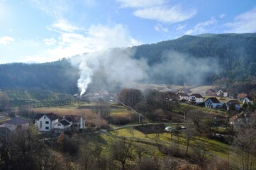 a mountain village and a burning fire and smoke