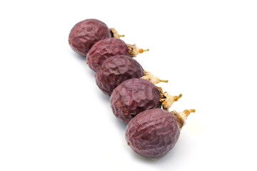 Three slice passion fruit with leaves on white background.
