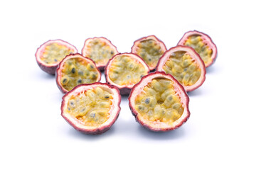Three slice passion fruit with leaves on white background.