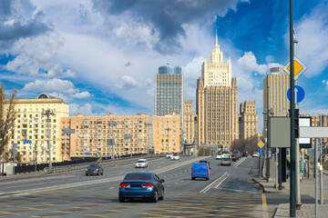 Fototapeta na wymiar Moscow roads. Russian architecture. Cars drive along road in center of Moscow. Road architecture of capital. Moscow streets. Automobile travel to capital of Russia. Russian Federation.