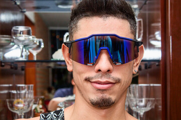 Smiling man in futuristic glasses Augmented reality, dream, future technology, gaming concept. VR.