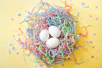 clean white chicken egg on colorful pastel paper filler background for gifts. easter party