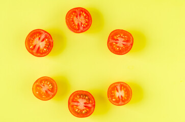 Fototapeta premium Cut tomatoes on yellow background