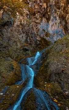 Long Exposure Shot Of A Waterfall Running On The Rocks