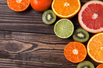 Fruit background. Kiwi, orange, tangerine, lime, grapefruit. Fresh citrus. Top view.