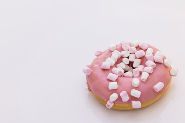 Bright and colorful sprinkled donut on a white background. Assortment of donuts of different flavors. Pink glazed marshmallow donut
