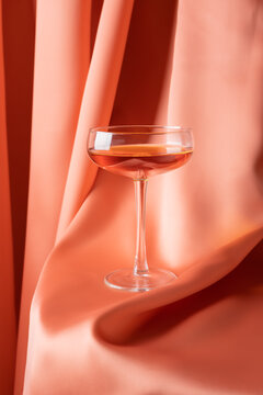 Glass of alcoholic drink on red fabric