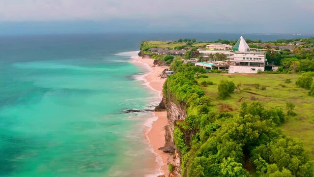Travel people standing on top mountain cliff on background nature landscape with coastline Dreamland beach, azure clear ocean and blue sky. 4K Aerial view