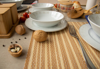 Table setting with white plates, blue napkins.