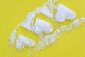 Heart made of snow, white powder.