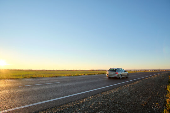 Car Driving Fast On Intercity Road At Sunset. Highway Traffic In Evening