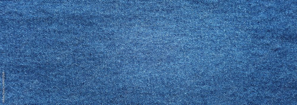 Wall mural Close-up of blue denim jeans fabric texture background