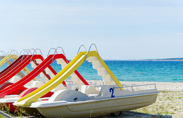 Boats with slides on a beach