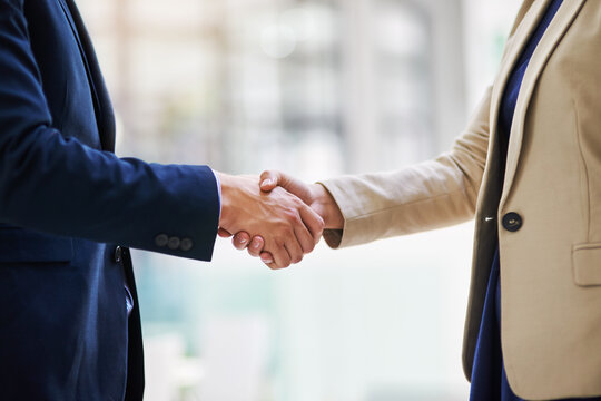 Forging new business associations. Shot of two businesspeople shaking hands.