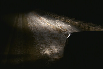 Light from car headlights at night in winter