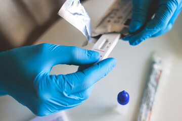Process of express fast coronavirus covid Antigen AG PCR testing examination at home, COVID-19 swab collection kit, test tube for taking OP NP patient specimen sample, testing carried out © tsuguliev