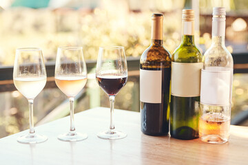 The only way to do wine tasting. Cropped shot of various wines lined up on a table for an outdoors wine tasting.