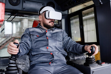 Confident male builder in vr headset and workwear holding by gearshifts while sitting inside...