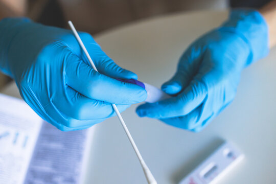 Process of express fast coronavirus covid Antigen AG PCR testing examination at home, COVID-19 swab collection kit, test tube for taking OP NP patient specimen sample, testing carried out