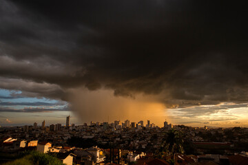 Varginha, Minas Gerais, Brazil: February 22, 2022: Torrential rain over downtown Varginha with heavy clouds at sunset