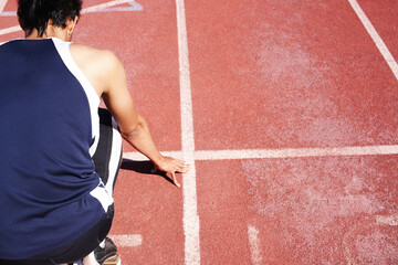 Hes right on track. A young athlete training alone. - Powered by Adobe
