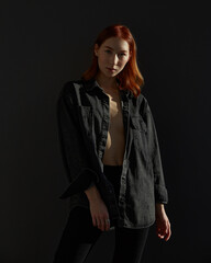 redhead model posing in studio on dark background