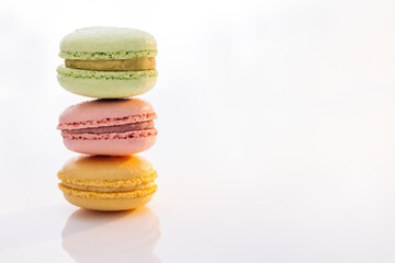 Three macarons against a bright white background. Sweet colorful macarons isolated on white background. Tasty colourful macaroons