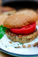 Chicken burgers cooking on an outdoor grill