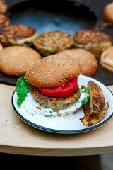 Chicken burgers cooking on an outdoor grill